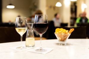 Zwei Gläser gefüllt mit kräftigem Rotwein und einem halb-trockenen Weiswein